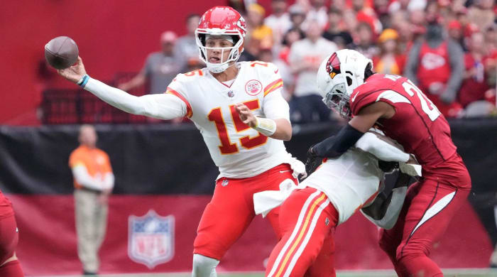 Sep 11, 2022; Glendale, Arizona, United States; Kansas City Chiefs quarterback Patrick Mahomes (15) throws a pass while pressured by Arizona Cardinals cornerback Marco Wilson (20) during the first quarter at State Farm Stadium.